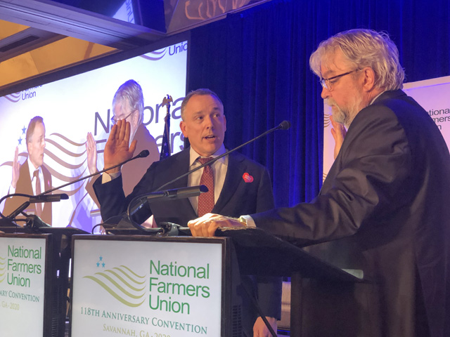 Rob Larew (left) was sworn in as president of the National Farmers Union on Monday at the group&#039;s annual meeting in Savannah, Georgia. He was sworn in by Dave Velde, NFU&#039;s chief counsel. Larew replaced Roger Johnson, who retired at the convention. (DTN photo by Chris Clayton) 